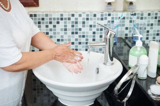 Senior washing hands in order to maintain good hygiene.
